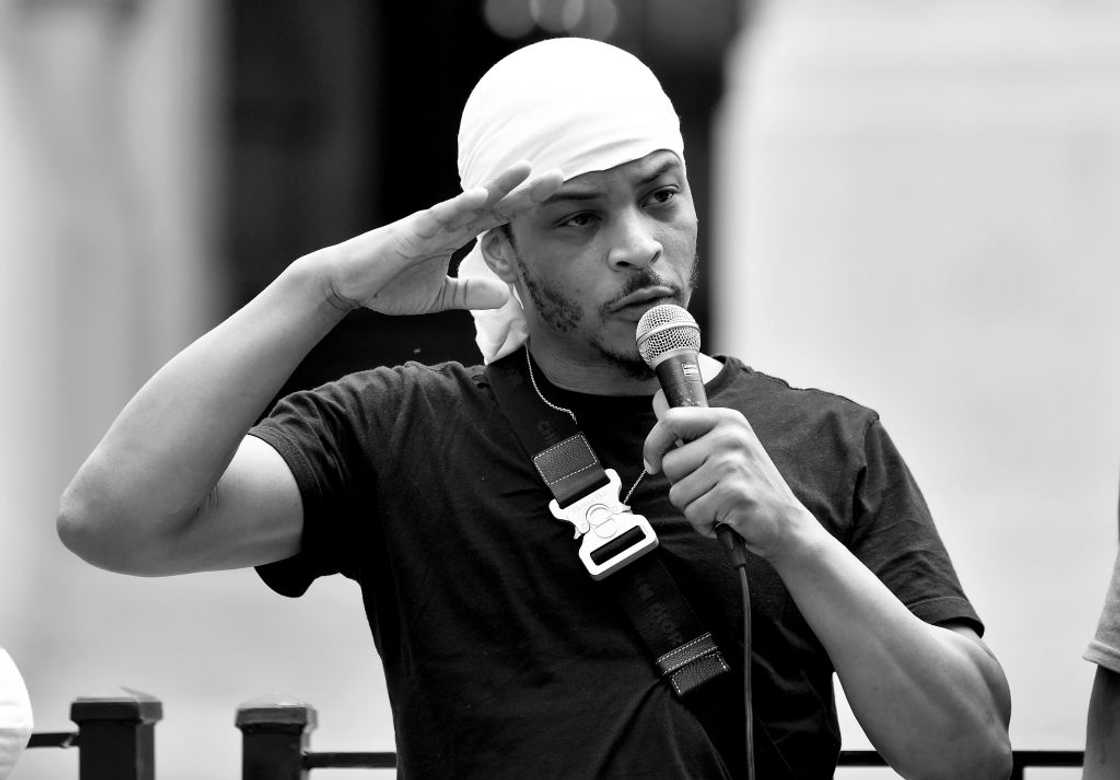 A black and white photo of T.I. speaking onstage at the Georgia State Capitol on A black and white photo of T.I. speaking onstage at the Georgia State Capitol on