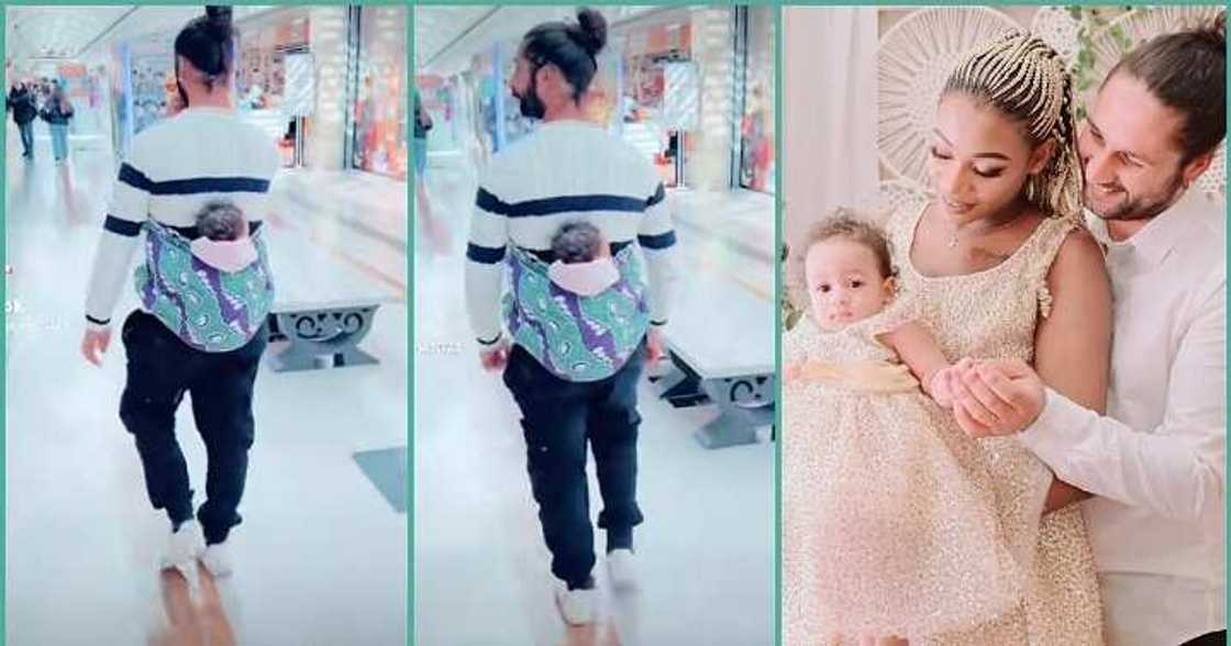 Oyinbo man melts hearts as he backs his baby with wrapper inside a mall