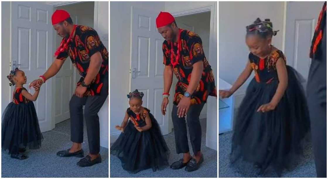 Nigerian man and his little daughter dressed in Isi-Agu material, dancing in a room. Nigerian man and his little daughter dressed in Isi-Agu material, dancing in a room.