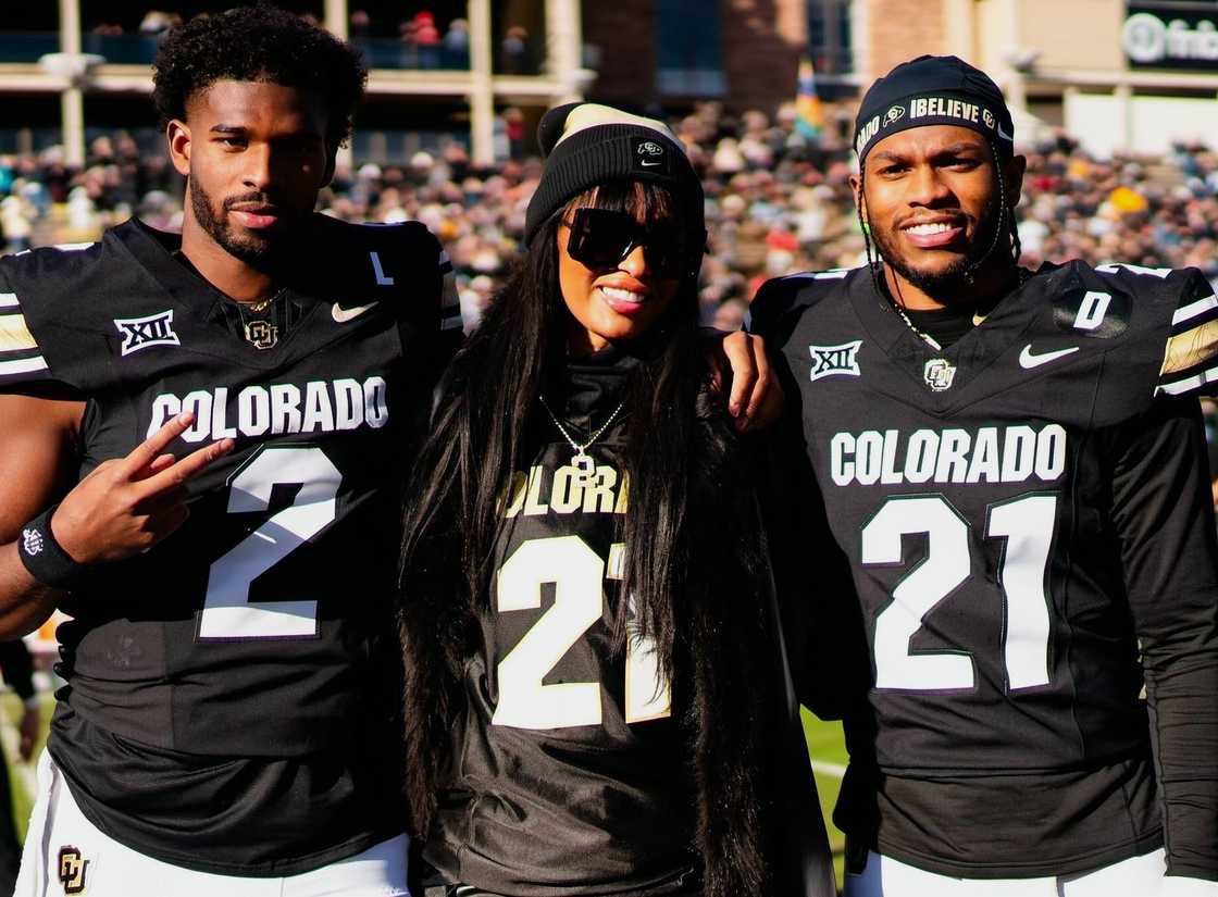 Shedeur Sanders, Pilar Sanders, and Shilo Sanders pose at a football stadium Shedeur Sanders, Pilar Sanders, and Shilo Sanders pose at a football stadium