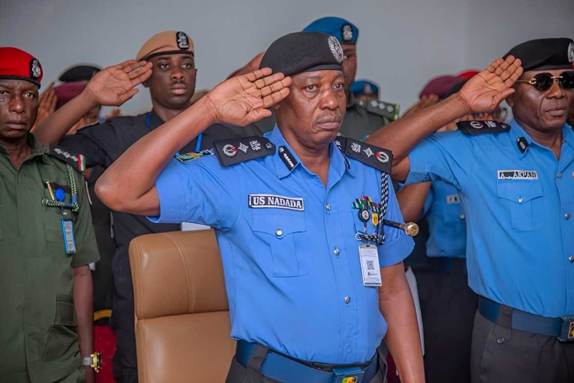 Nigerian police officers in a formal hand salute Nigerian police officers in a formal hand salute