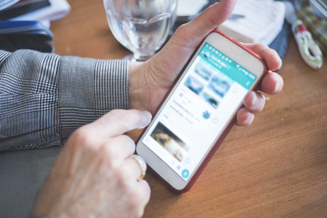 Woman looking staring at photos on WhatsApp Woman looking staring at photos on WhatsApp