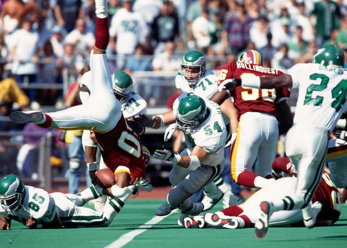 Washington Redskins running back Brian Mitchell dives to gain yardage at RFK Stadium in Washington, D.C. United States