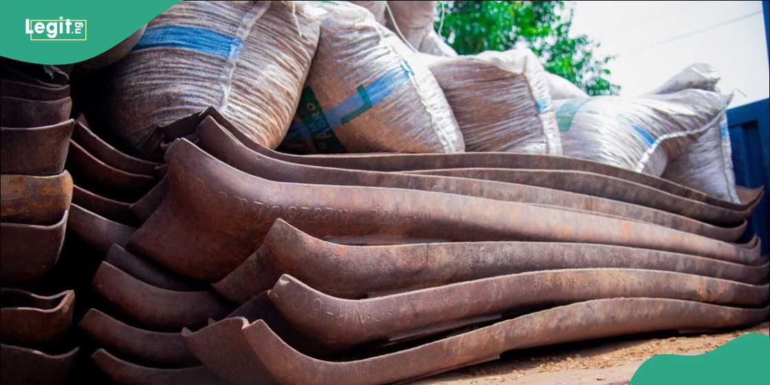 Police operatives inspecting seized railway tracks and sleepers valued at ₦400 million.