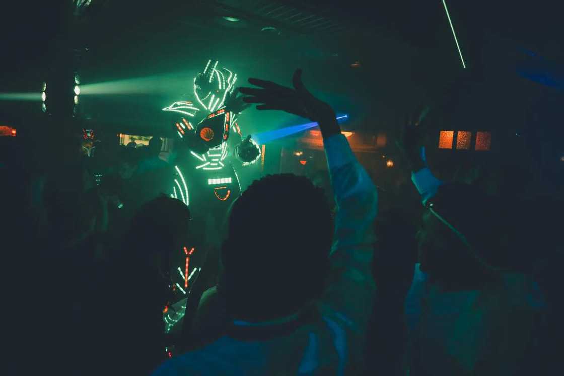 People dance to disco music in a nightclub People dance to disco music in a nightclub