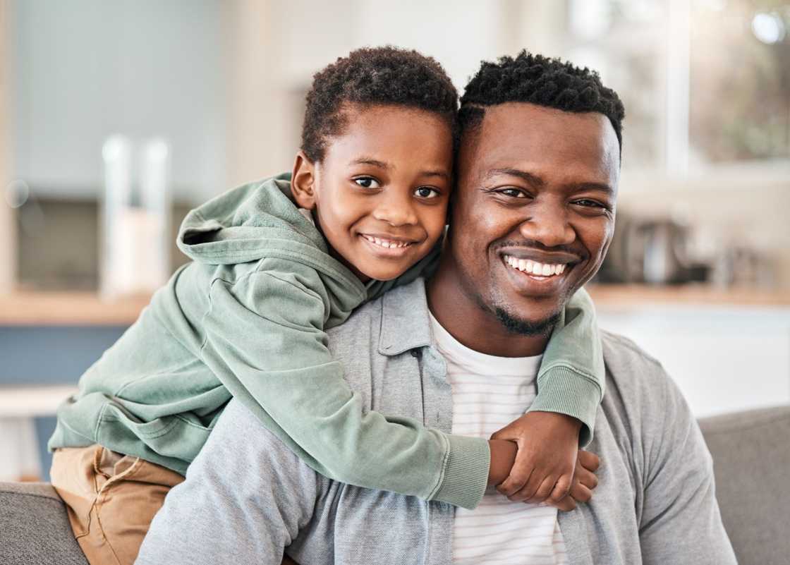 A little boy spending quality time with his father on the sofa at home