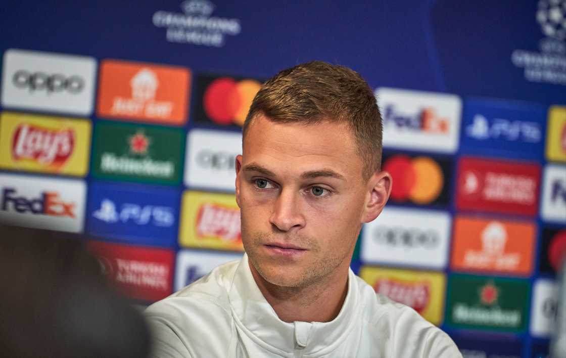 Joshua Kimmich of Fc Bayern Muenchen at the Press conference listening to a journalist at Parken Stadium