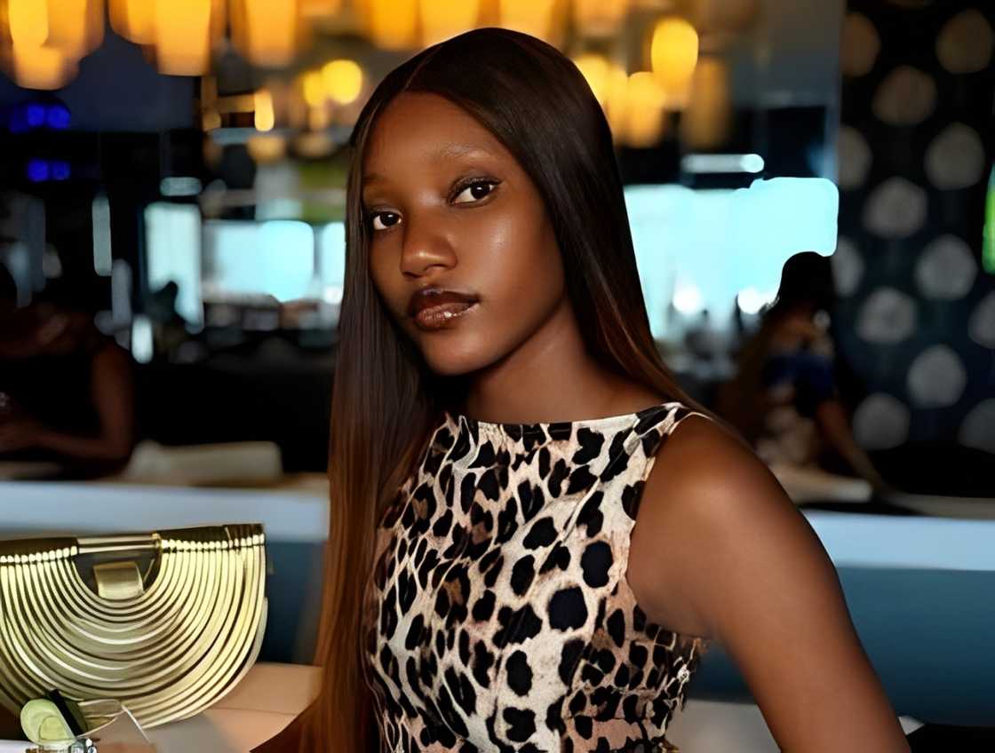 Oyindamola Oshikoya sits at a bar in a restaurant