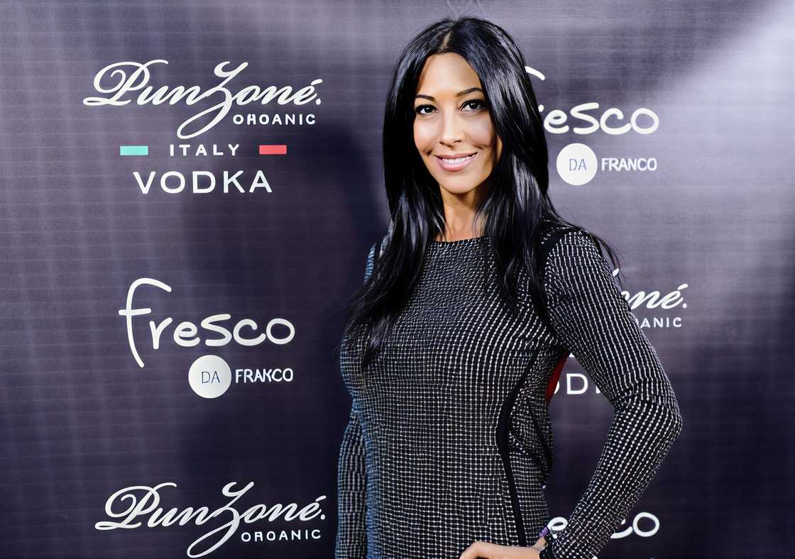 Carla Facciolo poses in a sequined dress against a promotional backdrop Carla Facciolo poses in a sequined dress against a promotional backdrop
