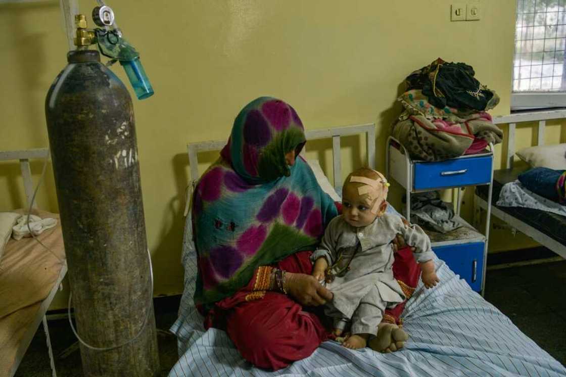 A woman cradles an injured child at the Sharan Hospital in Paktika province A woman cradles an injured child at the Sharan Hospital in Paktika province