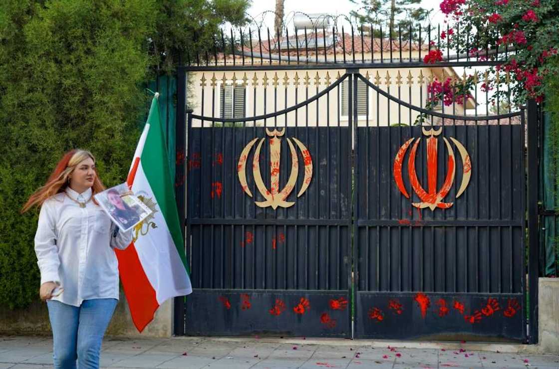 The entrance of Tehran's embassy is covered in red paint and palm prints during a rally organised by Iranian expats in support of protests in Iran The entrance of Tehran's embassy is covered in red paint and palm prints during a rally organised by Iranian expats in support of protests in Iran