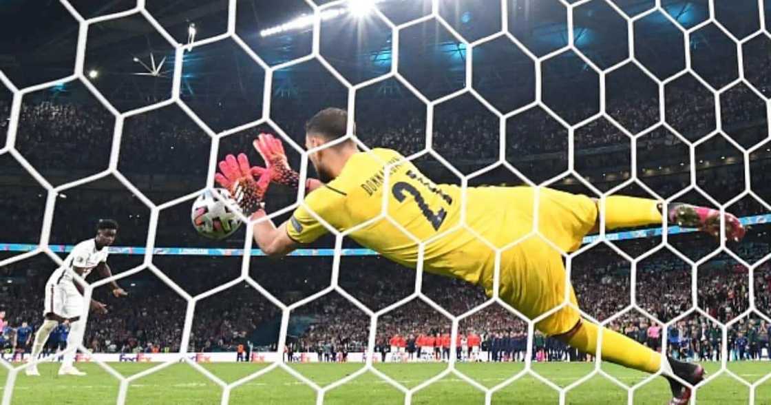 Italy keeper Donnarrumma saves Saka's crucial penalty. Photo by Paul ELLIS. Italy keeper Donnarrumma saves Saka's crucial penalty. Photo by Paul ELLIS.