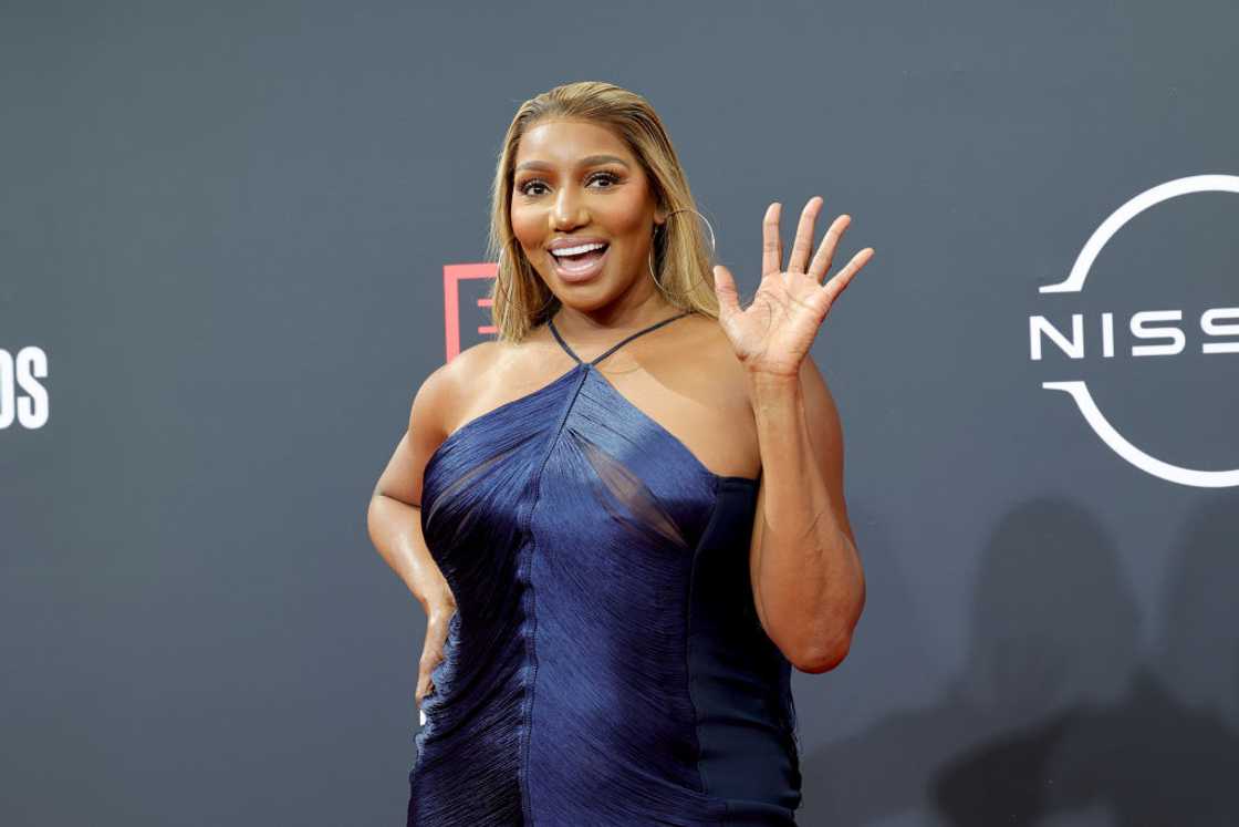 NeNe Leakes waving in a navy blue dreass at the 2022 BET Awards