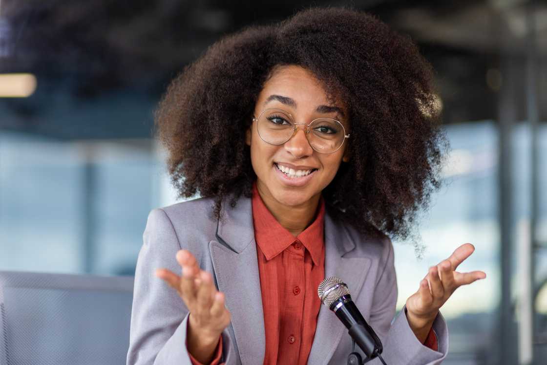A happy woman smiling while giving speech