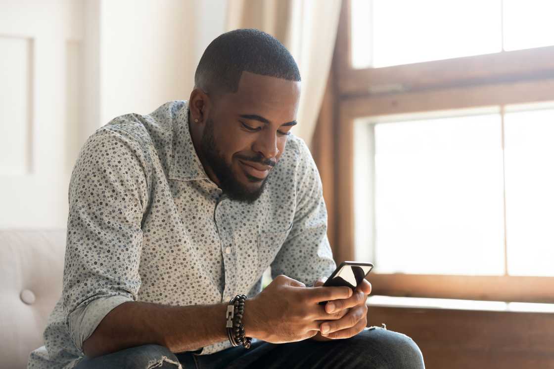 A man using his smartphone. A man using his smartphone.