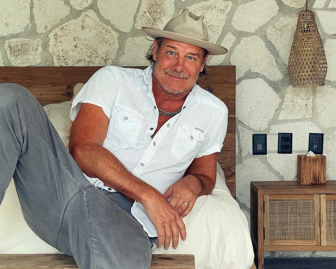 Ty Pennington posing on a bed Ty Pennington posing on a bed