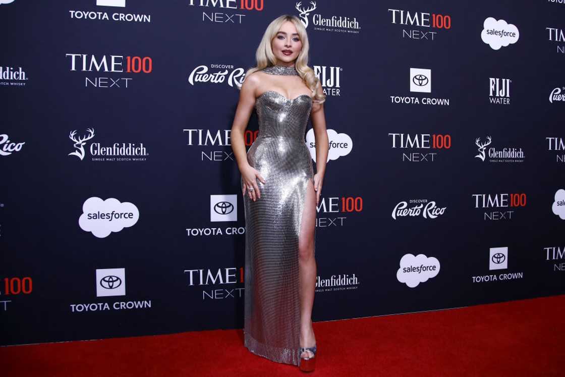 Sabrina Carpenter poses in a silver dress at the Time 100 Next event