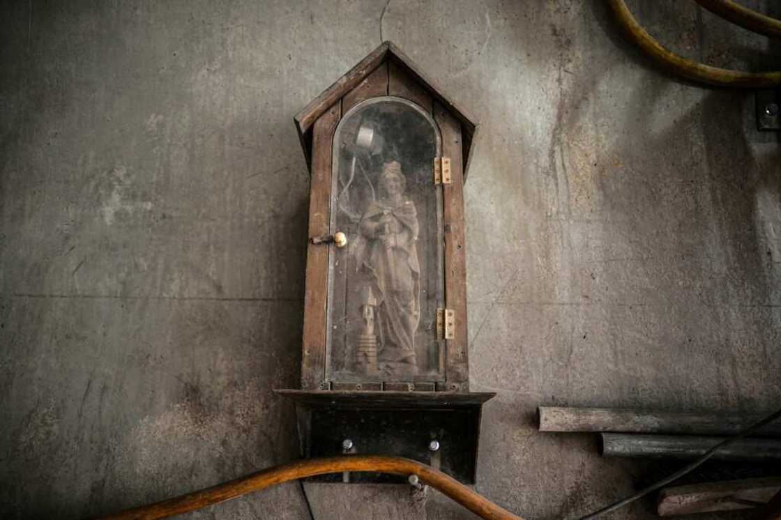 A statue of Saint Barbara, the patron of tunnelling, watches over the construction A statue of Saint Barbara, the patron of tunnelling, watches over the construction