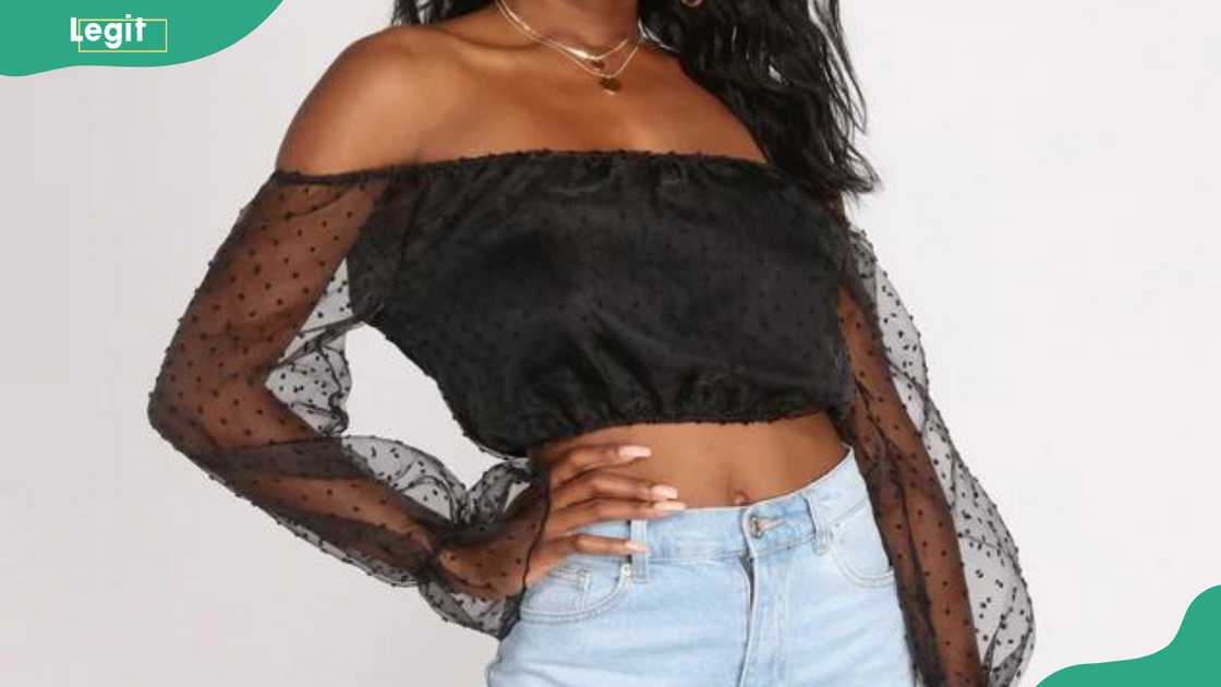 A lady showing a black off-shoulder organza top A lady showing a black off-shoulder organza top