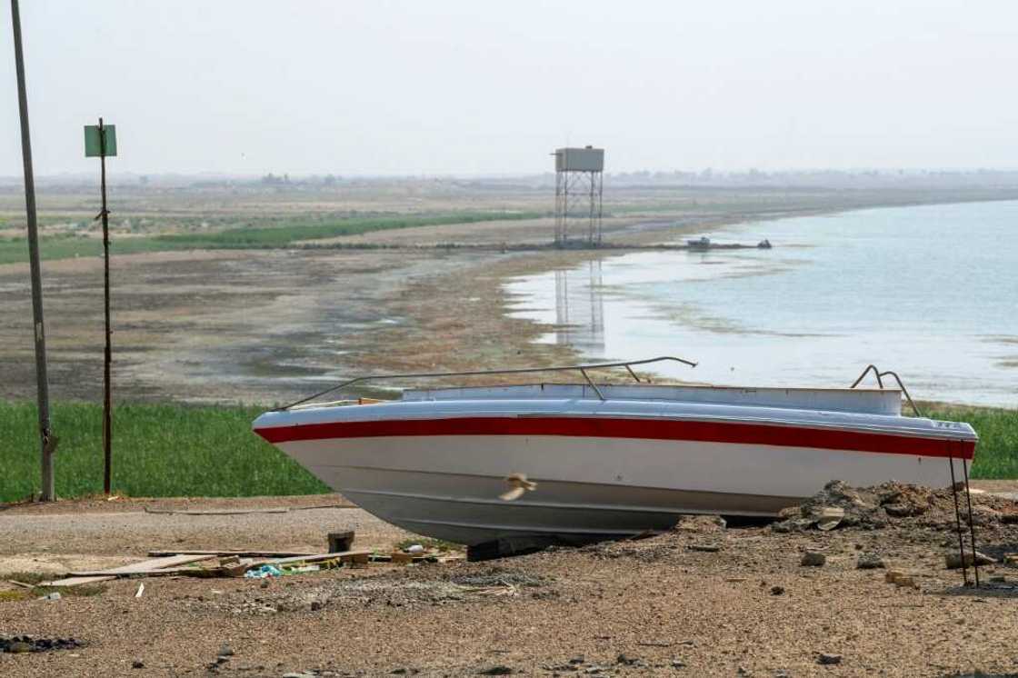 A boat is grounded by the receding shoreline of Iraq's Lake Habbaniyah, affected by a severe four-year drought A boat is grounded by the receding shoreline of Iraq's Lake Habbaniyah, affected by a severe four-year drought