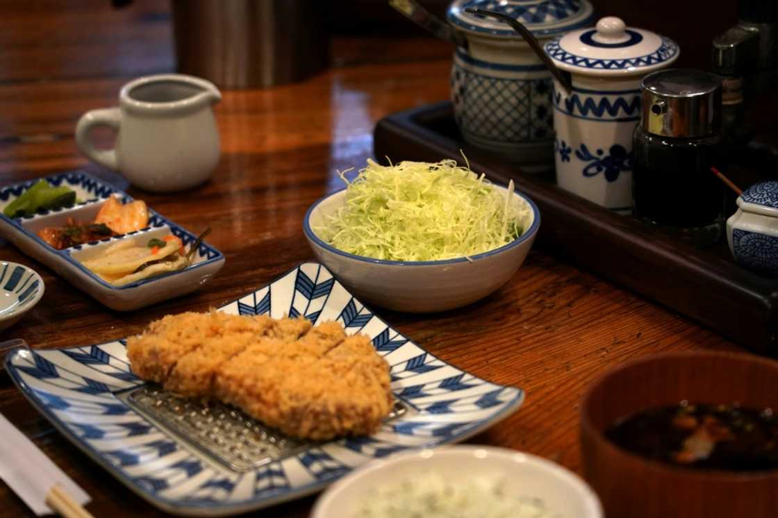 Japan's much-loved 'tonkatsu' pork cutlets come with a mound of freshly shredded cabbage, but a surge in the vegetable's price has prompted some chefs to skimp on servings Japan's much-loved 'tonkatsu' pork cutlets come with a mound of freshly shredded cabbage, but a surge in the vegetable's price has prompted some chefs to skimp on servings