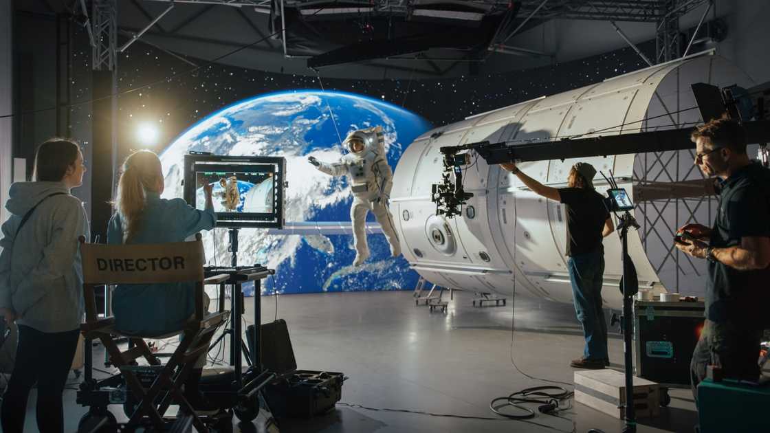 A behind-the-scenes shot of the filming process of a Sci-fi movie with an astronaut and space visuals. A behind-the-scenes shot of the filming process of a Sci-fi movie with an astronaut and space visuals.