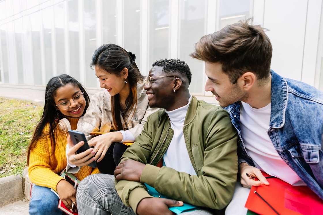 Four students laughing during a funny moment.