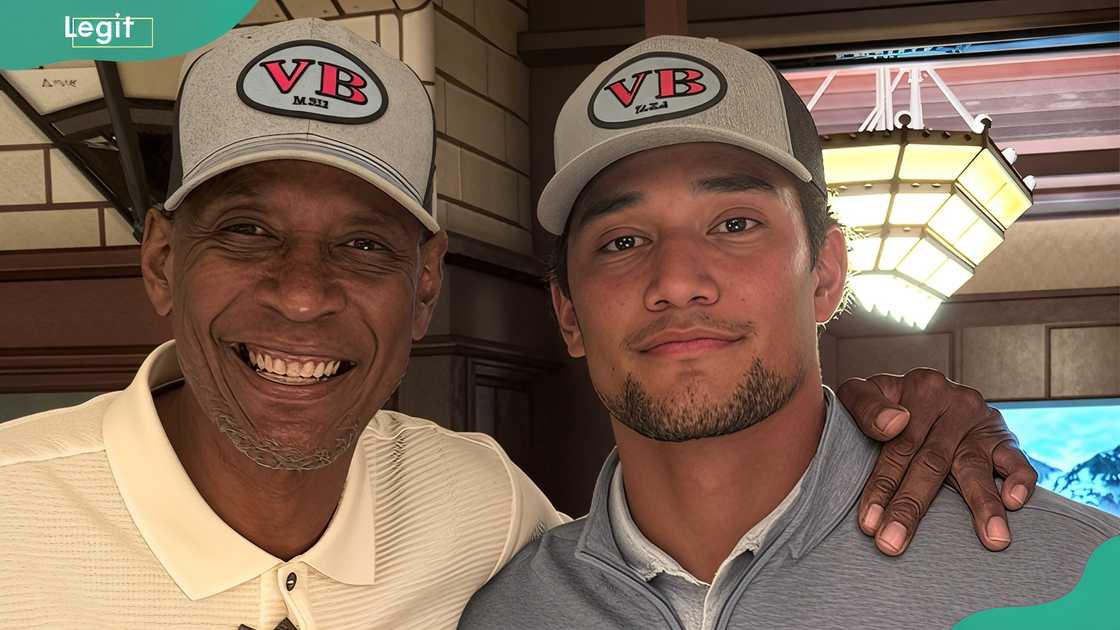 Kyle Hamilton and his father posing for a photo