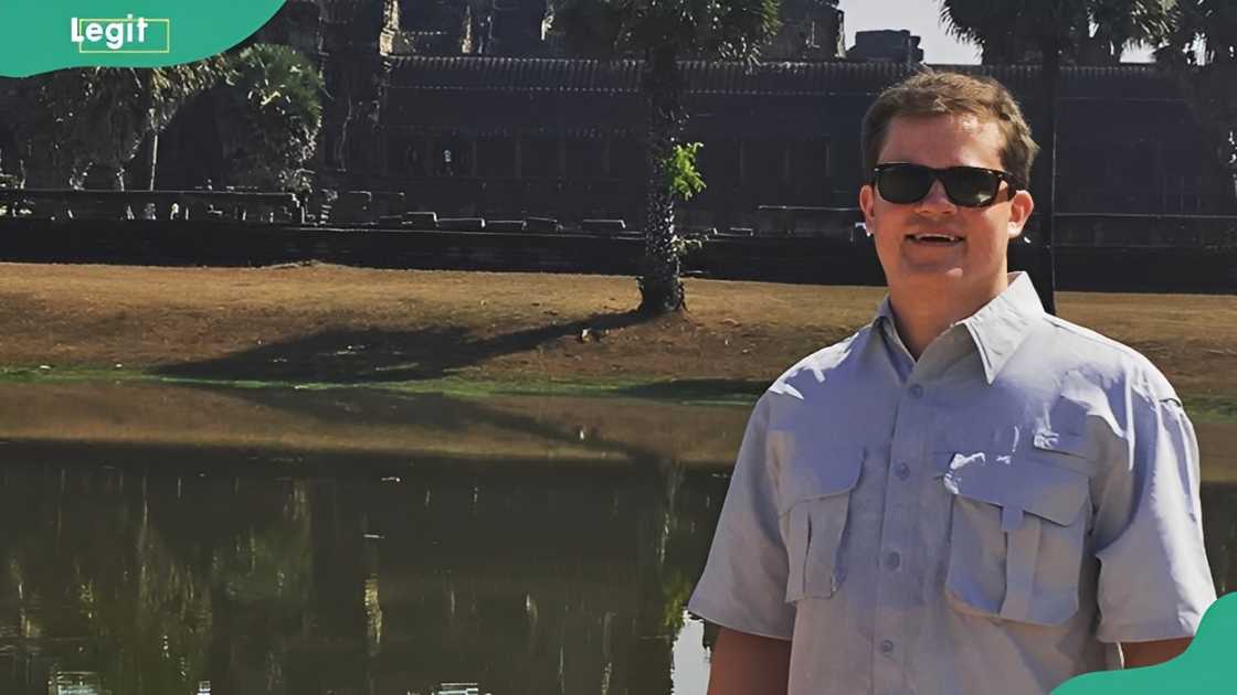 Jett Puckett poses for a photo next to a pool of water