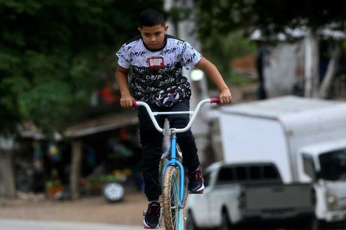 When there are no clients, Eduardo rides his bicycle or plays with his friends