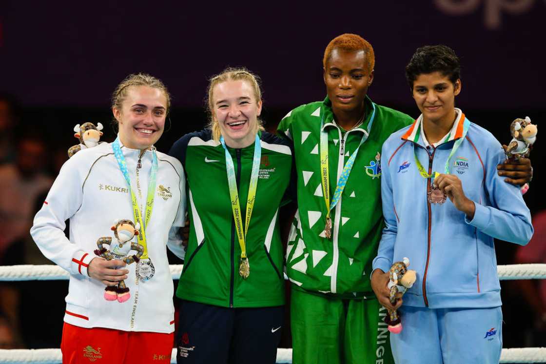 Cynthia Ogunsemilore (second from right) celebrates with other women boxers at the 2022 Commonwealth Games.