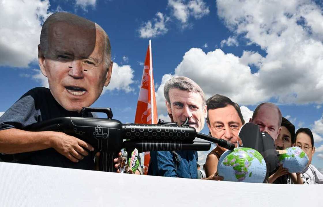 Protesters wearing masks depicting G7 leaders take part in a demonstration called by environmental groups to warn against rolling back on climate commitments Protesters wearing masks depicting G7 leaders take part in a demonstration called by environmental groups to warn against rolling back on climate commitments