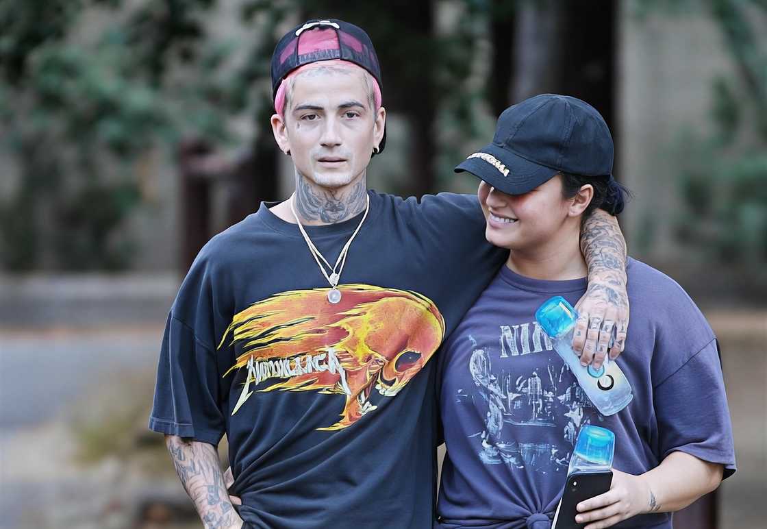 Austin Wilson and Demi Lovato holding each other in the street