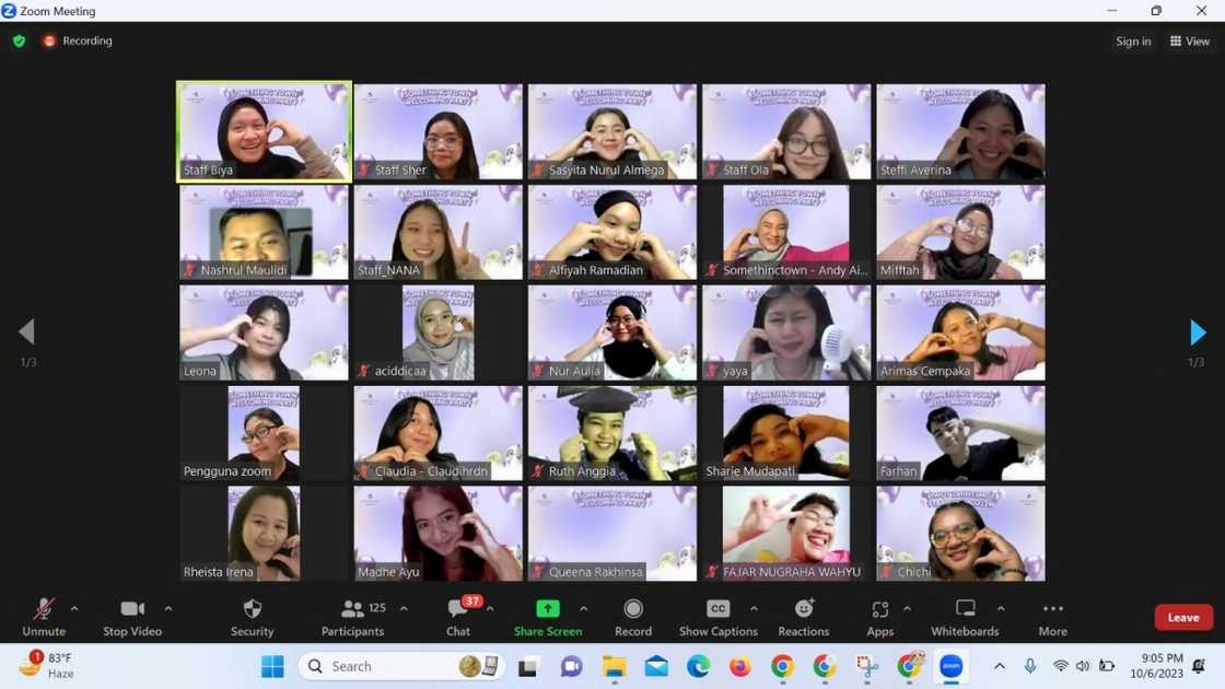 Students show the heart symbol using their hands during a Zoom call. Students show the heart symbol using their hands during a Zoom call.