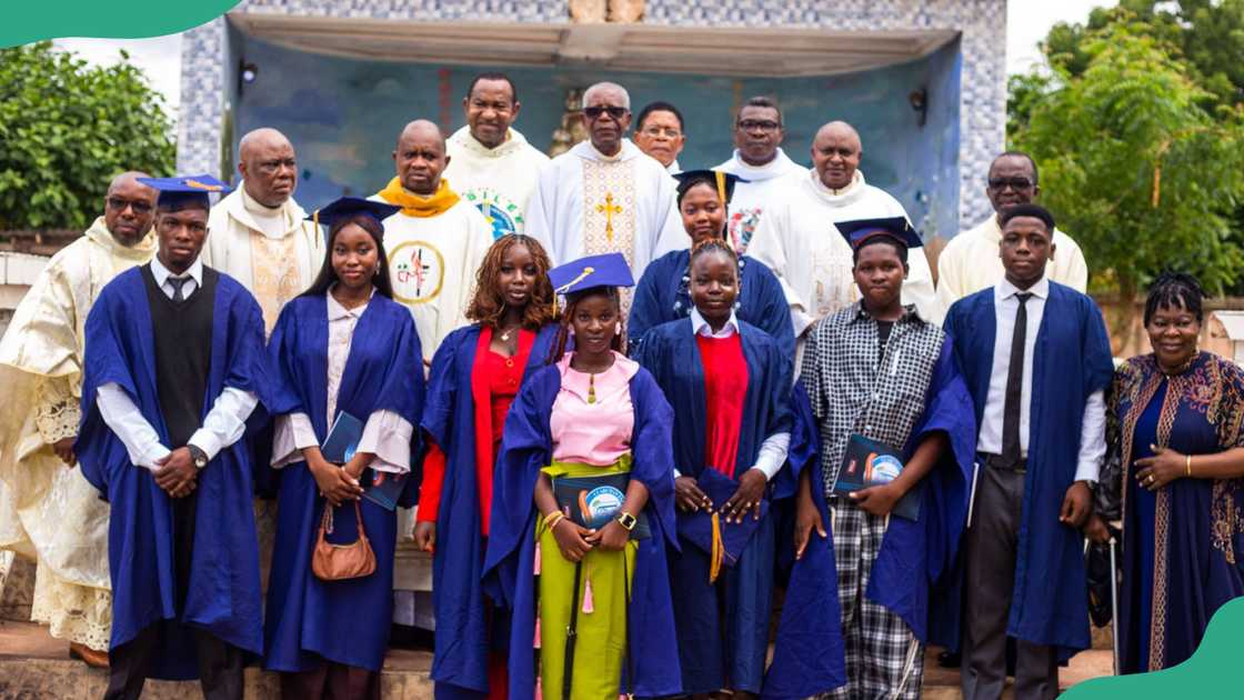 Priests and students pose for a photo