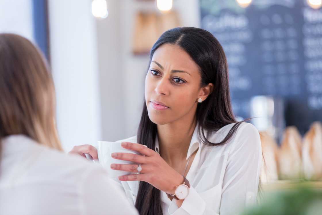 Two ladies at a cafe talking Two ladies at a cafe talking