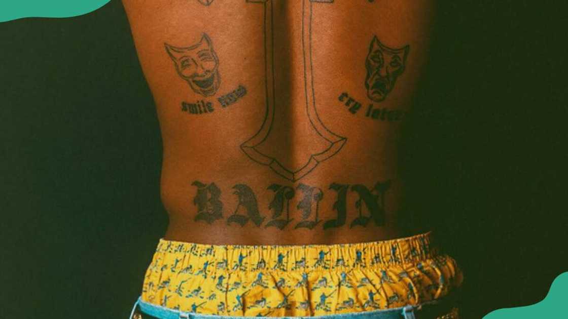 BALLIN tatt on his lower back BALLIN tatt on his lower back