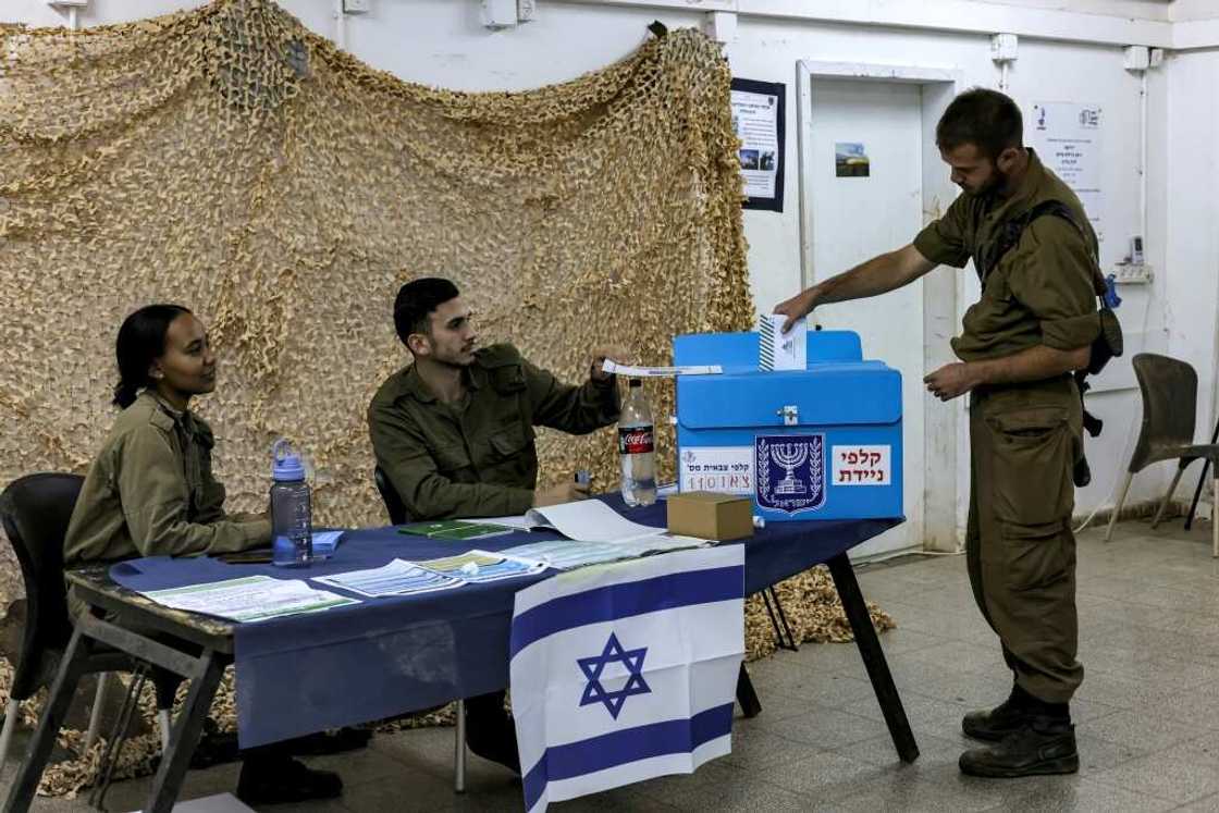 An Israeli soldier casts a ballot a day early at Har Dov military base on Mount Hermon, a strategic and fortified outpost at the crossroads between Israel, Lebanon, and Syria, in the Israeli-annexed Golan Heights