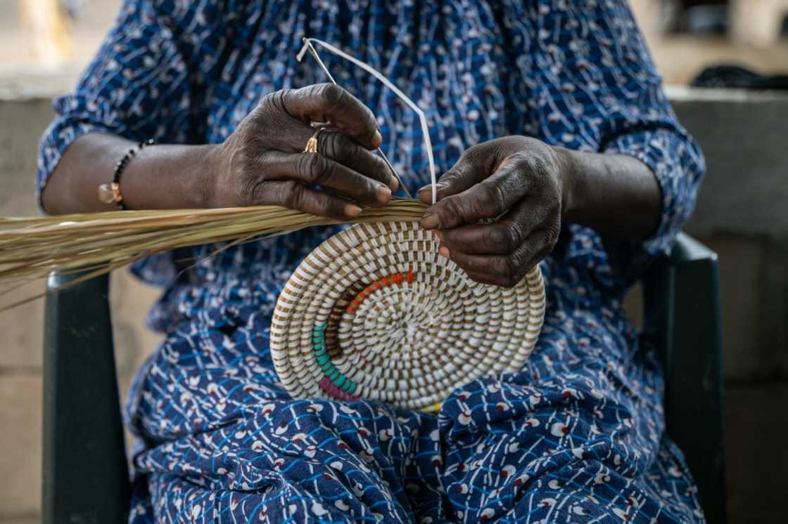 Senegalese-style baskets consist of coiled reeds wound together with colourful plastic strips, which in the olden days would have been palm fibres Senegalese-style baskets consist of coiled reeds wound together with colourful plastic strips, which in the olden days would have been palm fibres