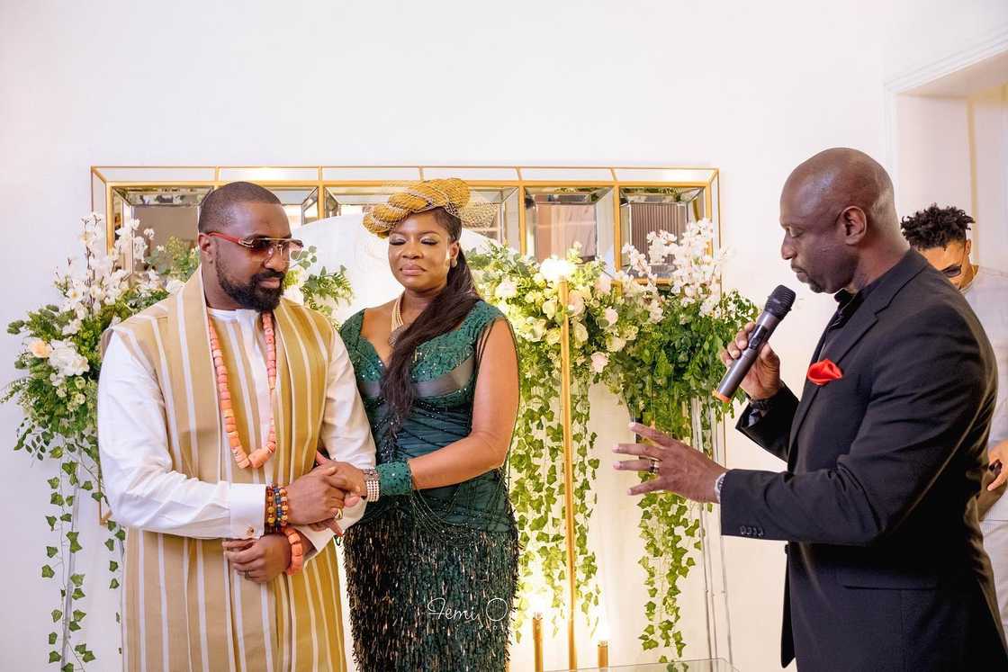 Kemi Adetiba and her husband Oscar Heman-Ackah being prayed for by a pastor