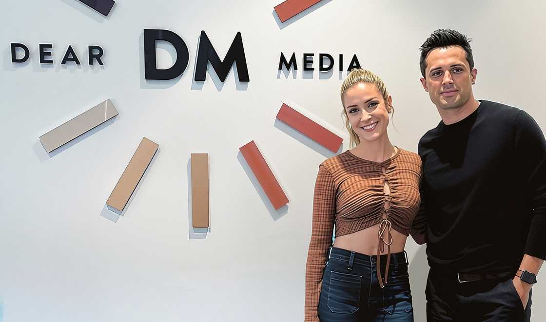 Kristin Cavallari and Stephen Colletti pose standing in front of the Dear Media logo Kristin Cavallari and Stephen Colletti pose standing in front of the Dear Media logo