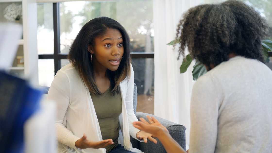 Daughter and mother in a heated conversation Daughter and mother in a heated conversation