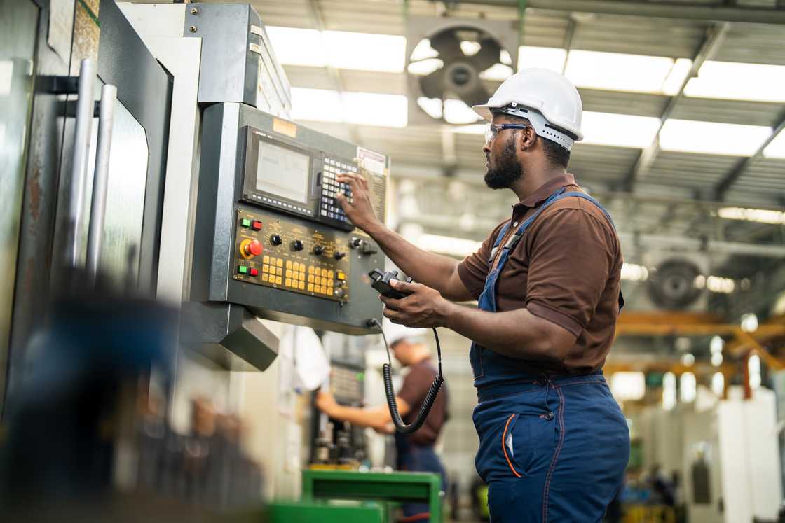 An engineer operateing a machine in a modern factory.