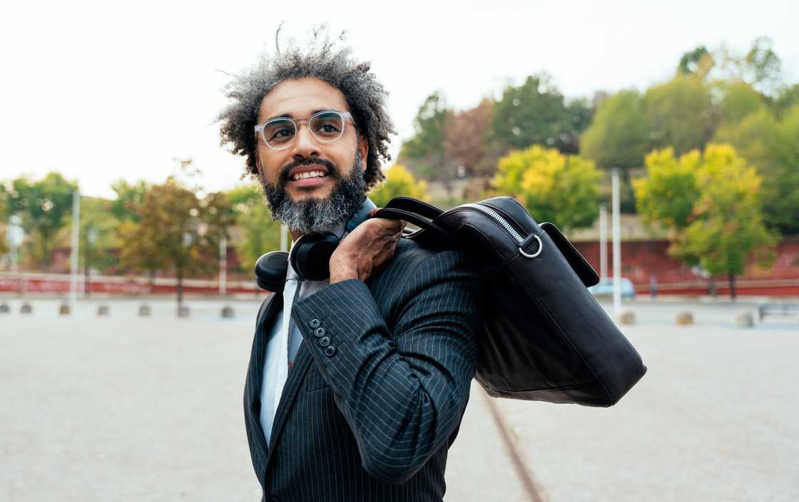 A lawyer walks past the courthouse gates carrying a briefcase.