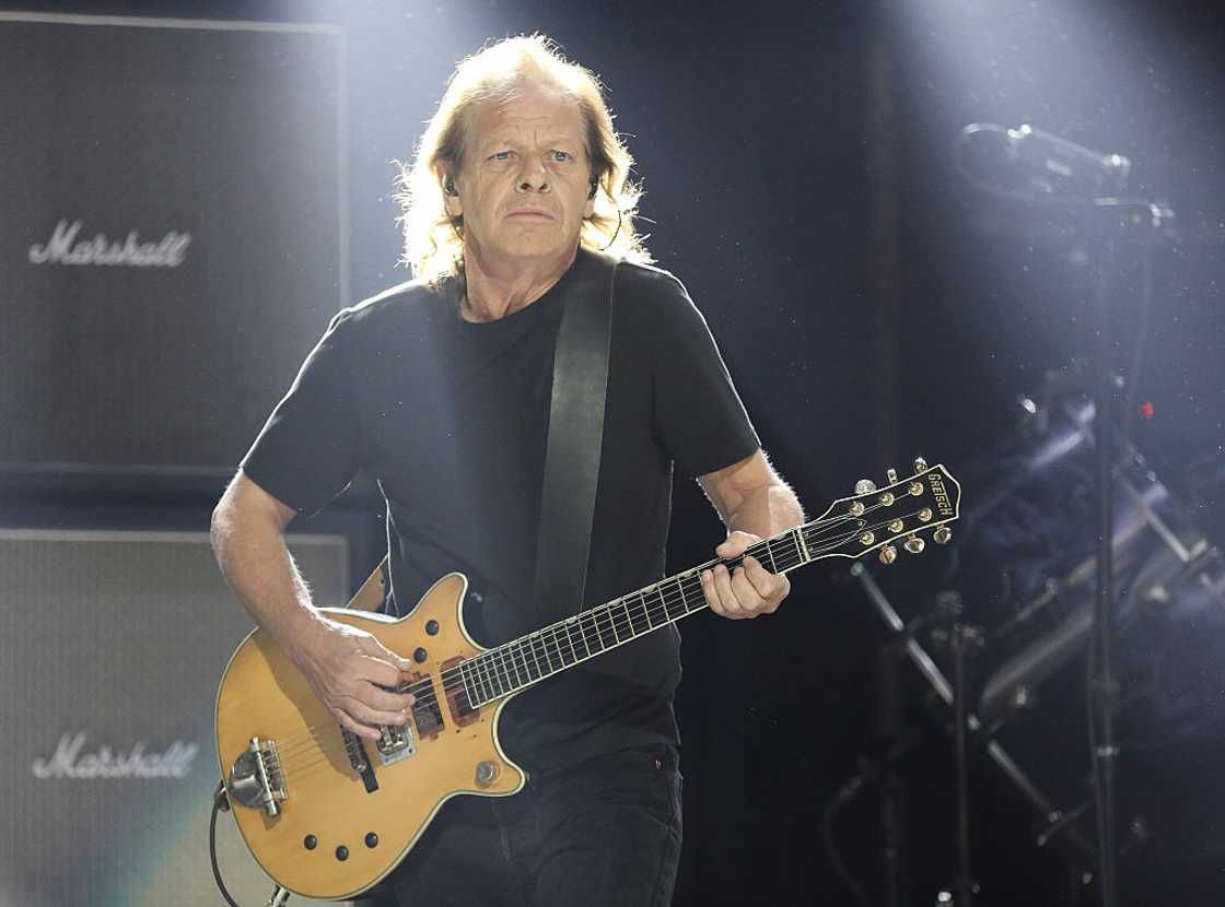 Stevie Young playing the guitar on stage