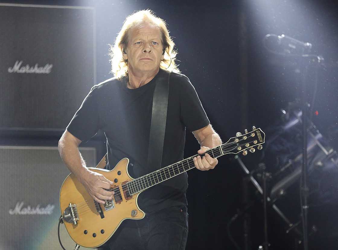 Stevie Young playing the guitar on stage Stevie Young playing the guitar on stage