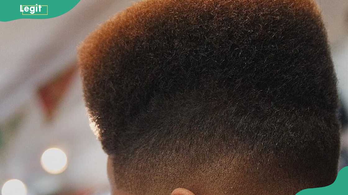 a rounded top with temple fade hairstyle for men