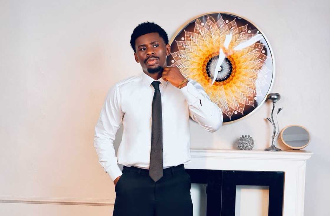 Victory Okokon posing next to a console table Victory Okokon posing next to a console table