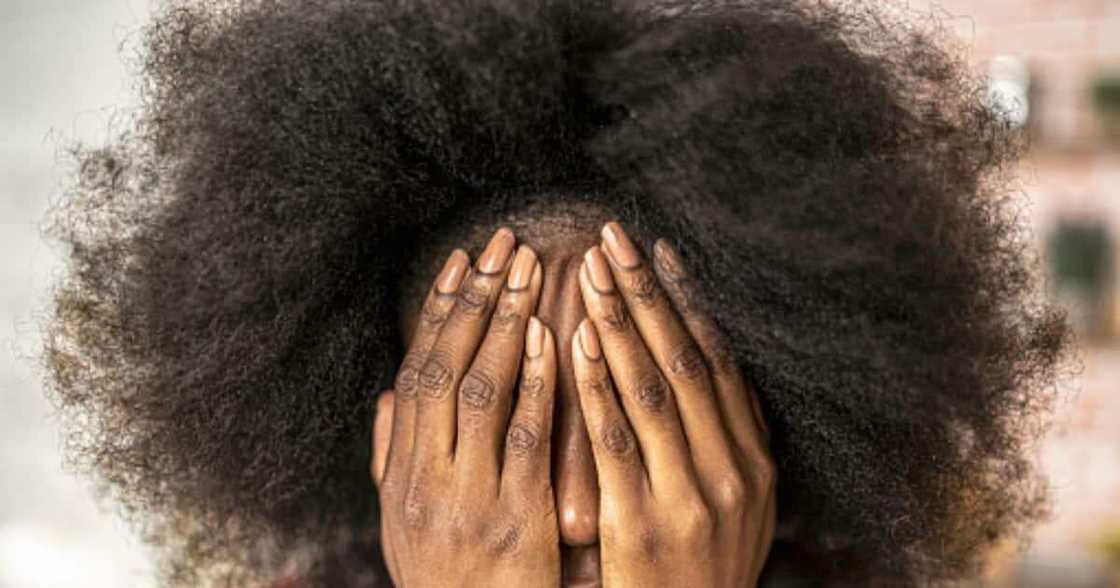 Woman sitting at home hands on face. Woman sitting at home hands on face.