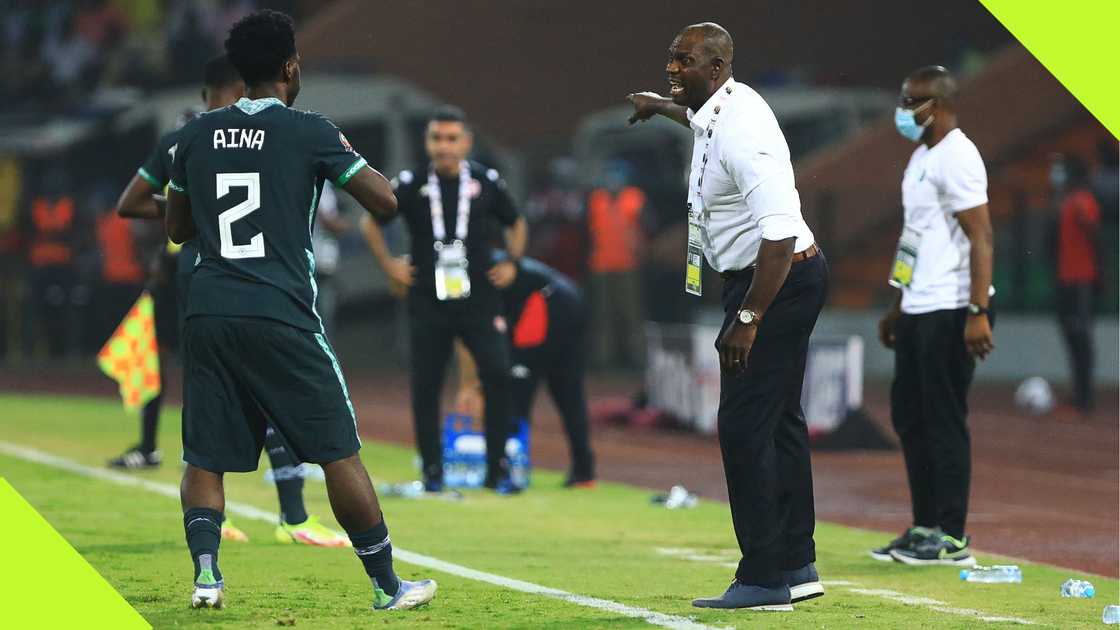 Augustine Eguavoen passing instructions to Ola Aina during AFCON 2021 match against Tunisia.